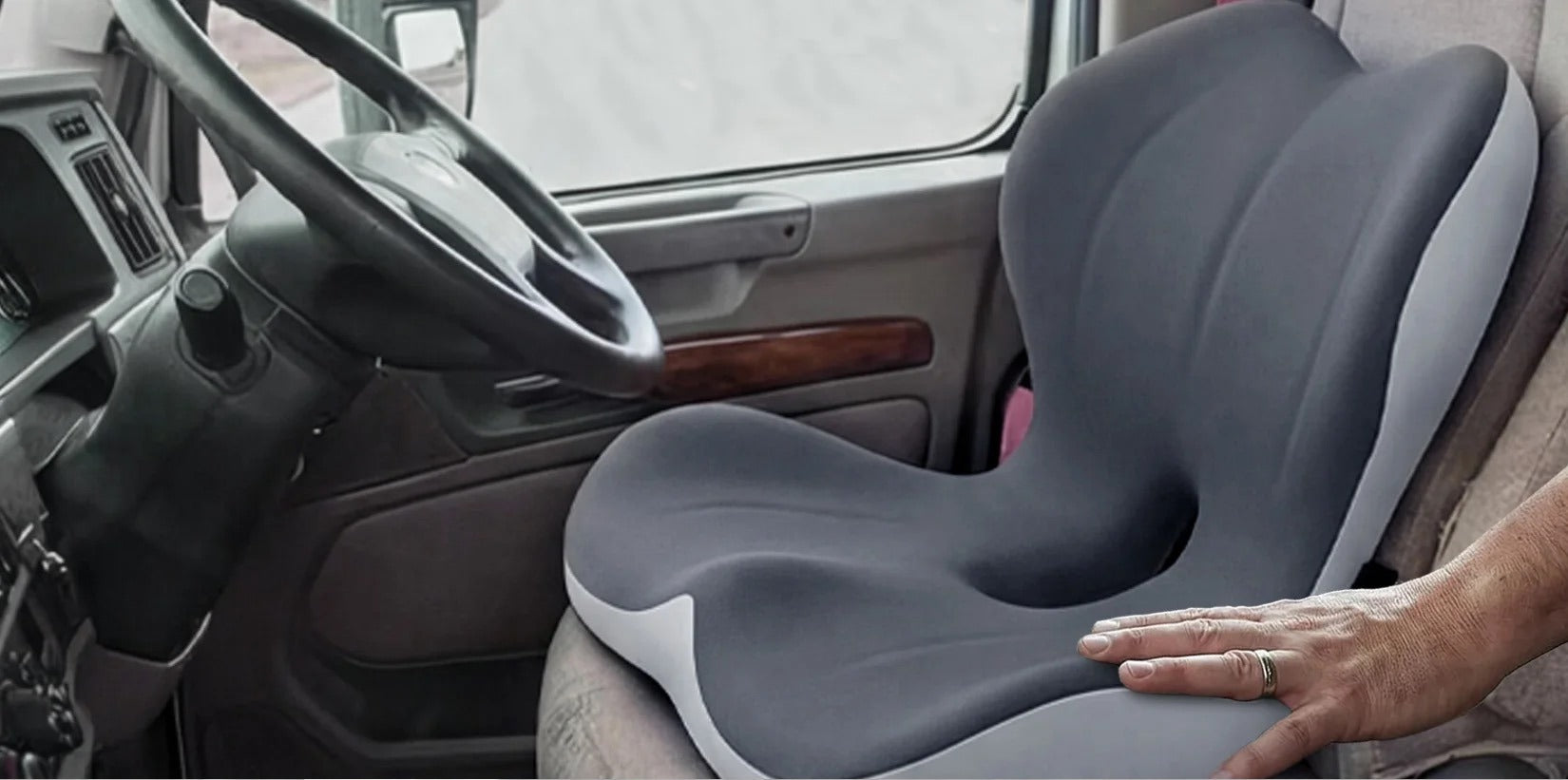 The cushion strapped into a truck driver's seat